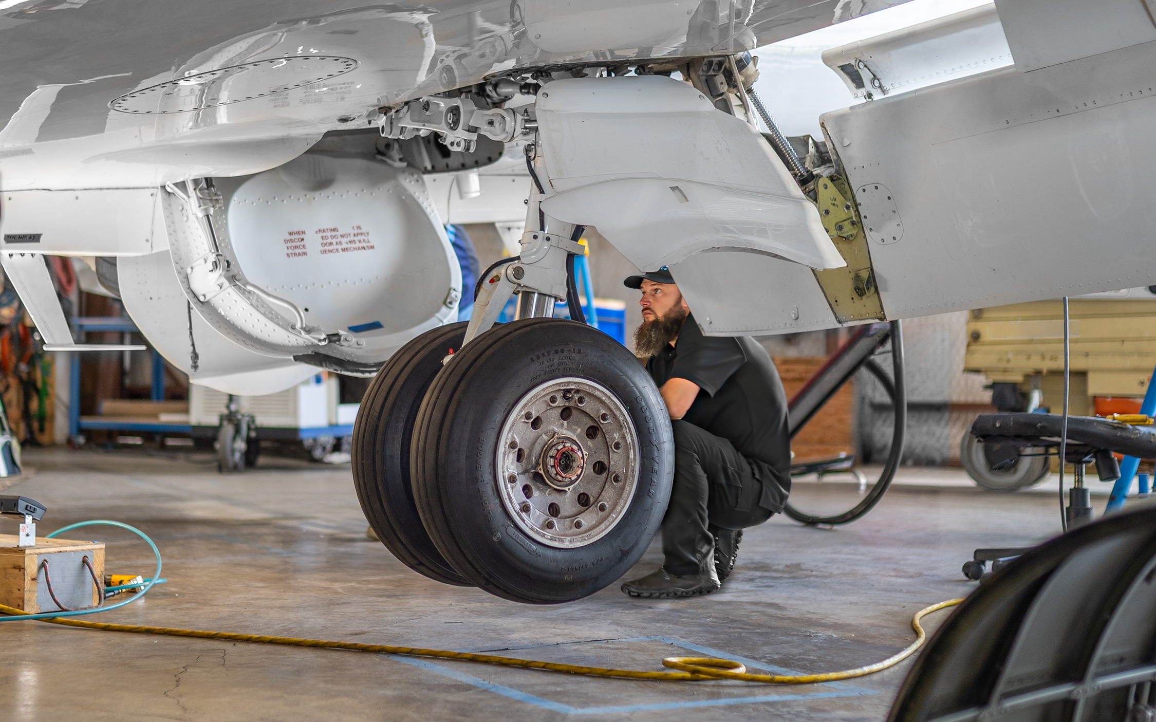 Plane Place Aviation technicians performing a landing gear inspection on a Hawker