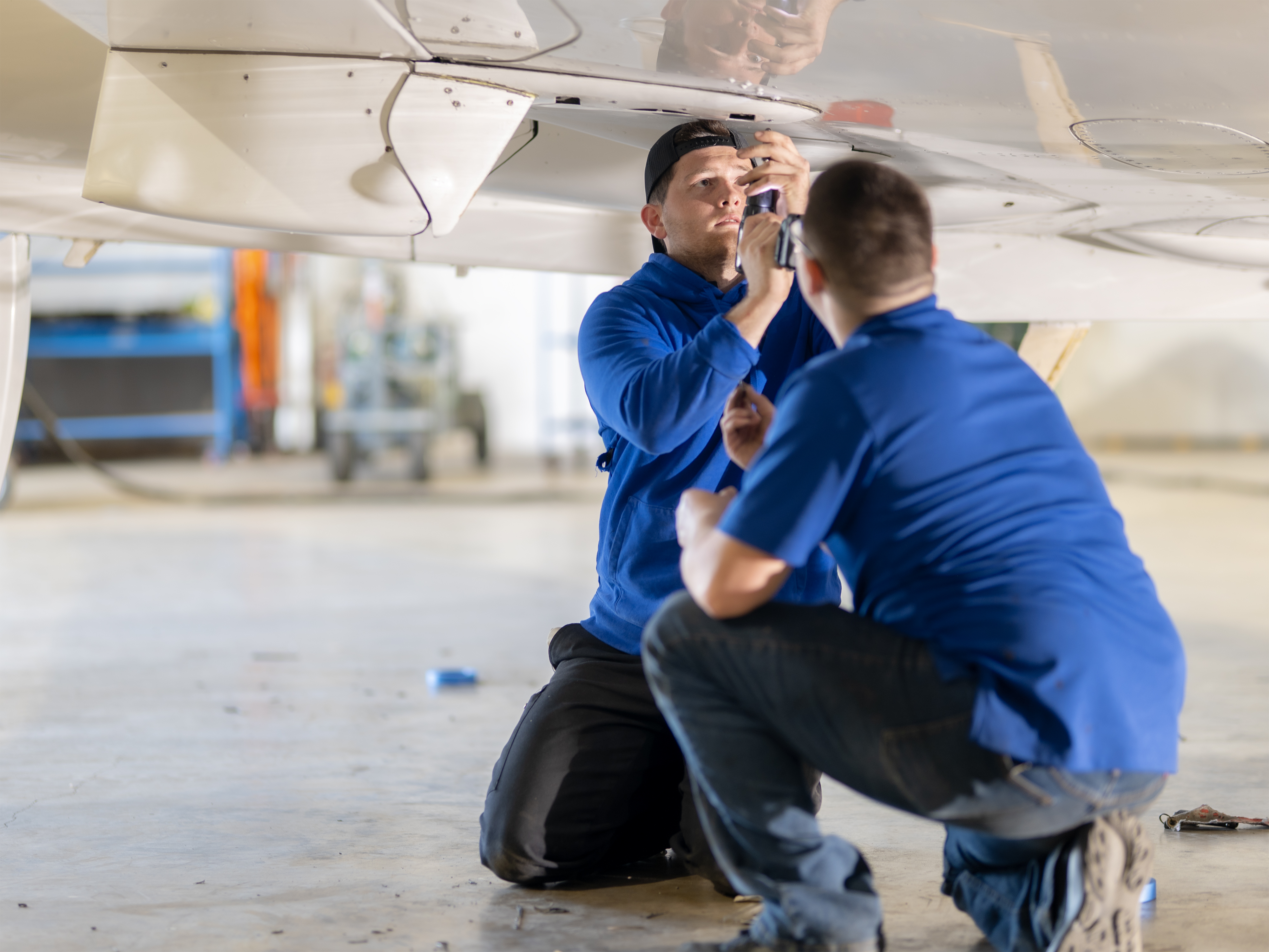 PPA technicians inspecting the underside of a Citation aircraft wing