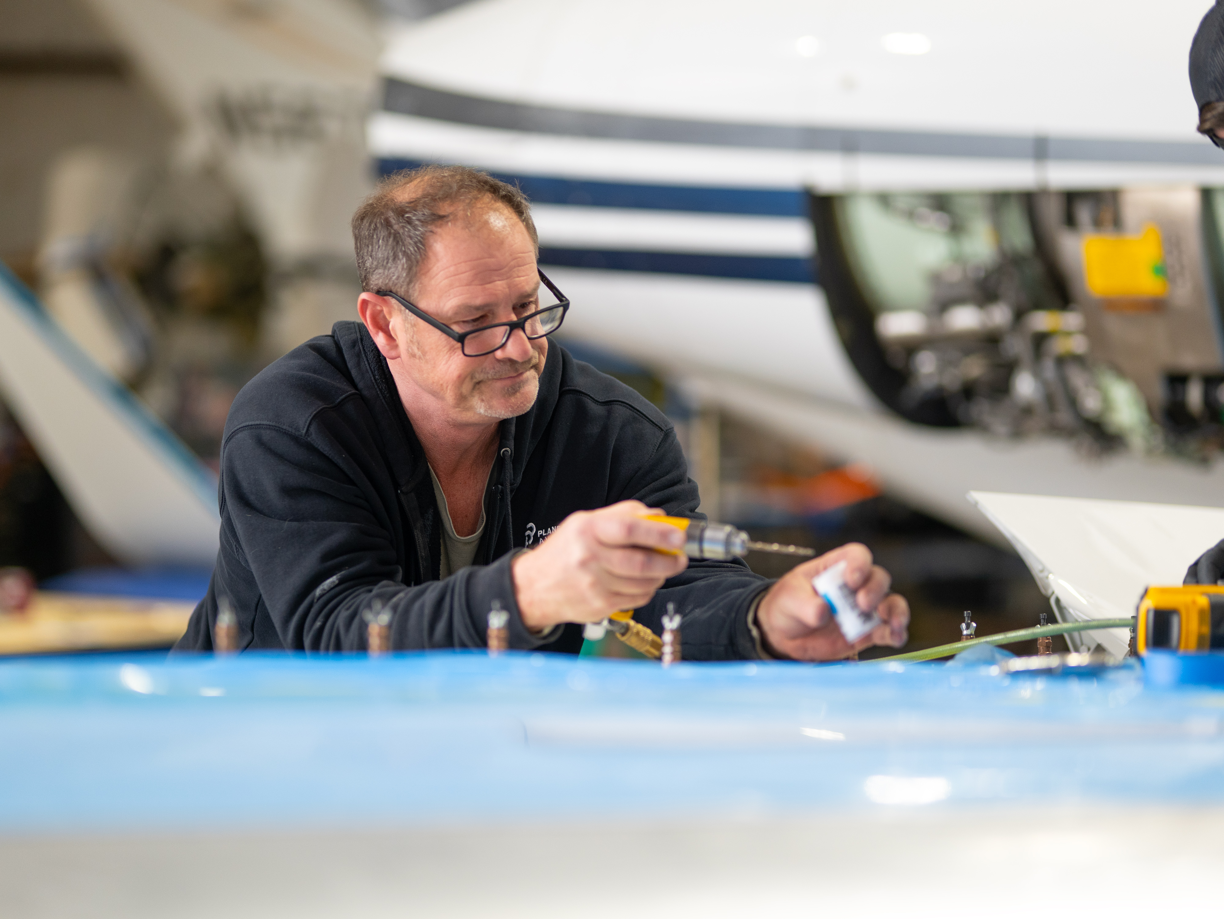 Senior PPA technician performing precision riveting work